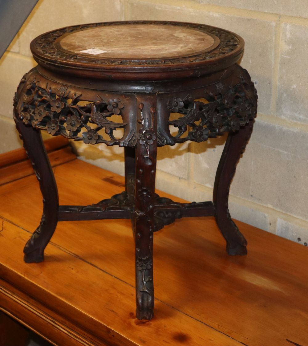 A 19th century Chinese carved hardwood marble top jardiniere stand, 48cm diameter, H.48cm